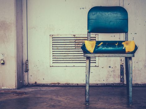 A Grungy Retro Damaged Chair Outside  A Workplace