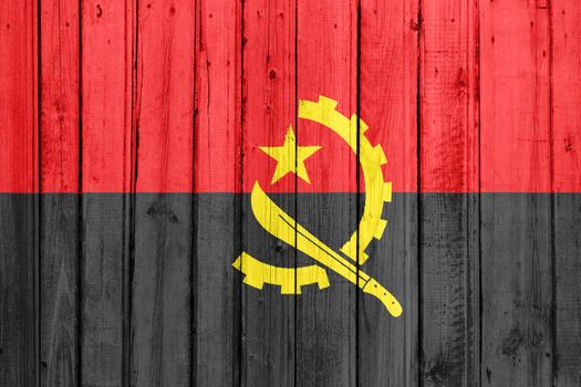 The Angolan flag painted on a wooden fence