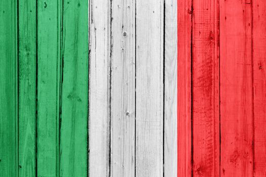 The Italian flag painted on a wooden fence