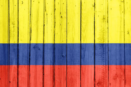 The Colombian flag painted on a wooden fence