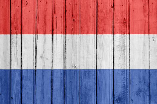 The Netherlands flag painted on a wooden fence