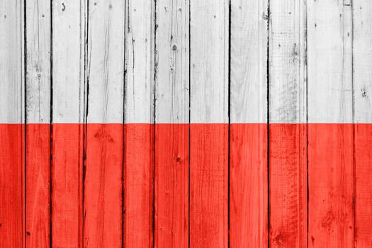 The Polish flag painted on a wooden fence