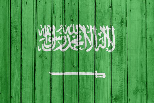 The Saudi Arabia flag painted on a wooden fence