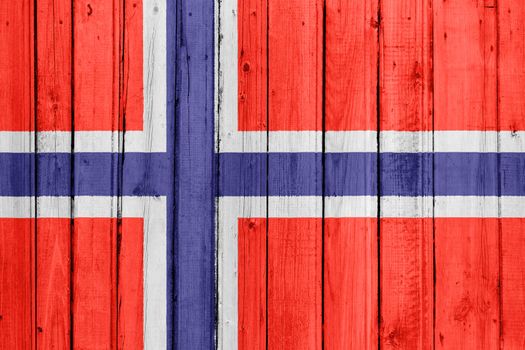 The Norwegian flag painted on a wooden fence