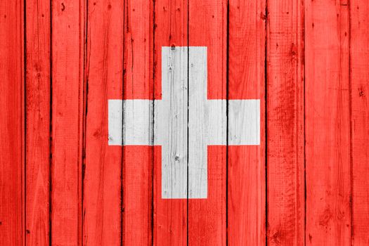 The Swiss flag painted on a wooden fence