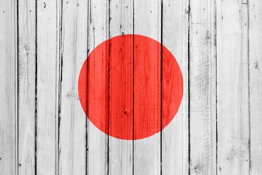 The Japan flag painted on a wooden fence
