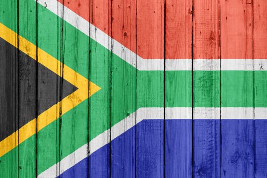 The Republic of South Africa flag painted on a wooden fence