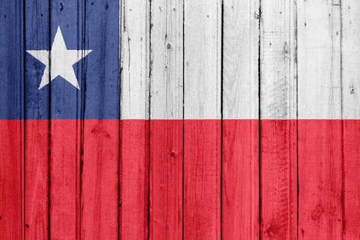 The Chile flag painted on a wooden fence