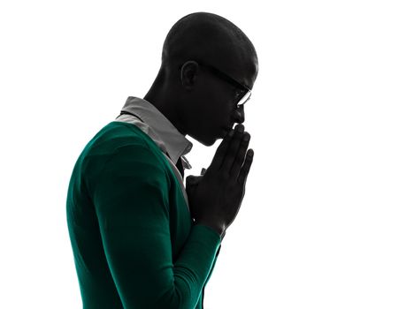 one african black man thinking pensive praying silhouette in silhouette studio on white background