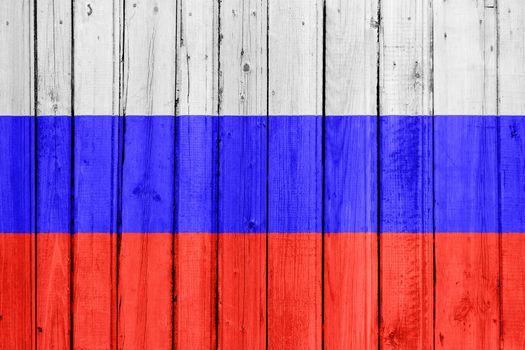 The Russian flag painted on a wooden fence