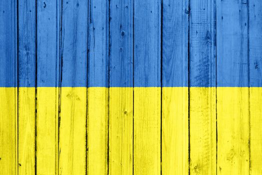 The Ukrainian flag painted on a wooden fence