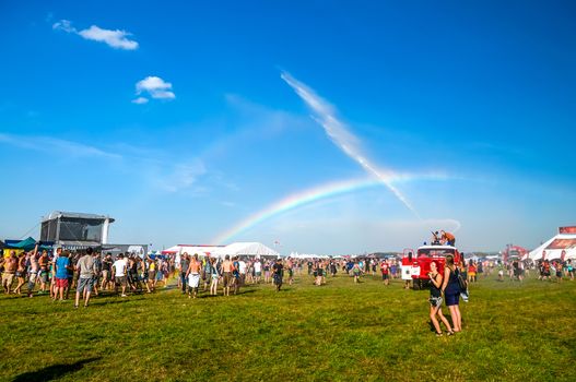 People enjoy the water from a fire truck at Mighty Sounds festival 19th of July, 2013