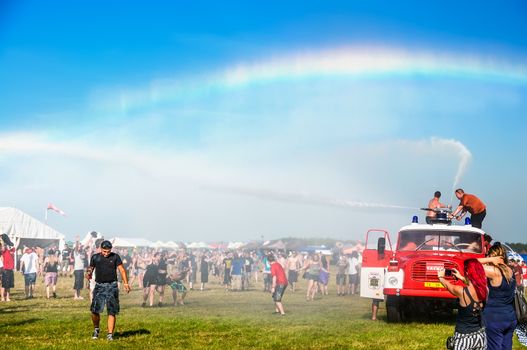 Water from a fire truck creates a rainbow at Mighty Sounds festival 19th of July, 2013