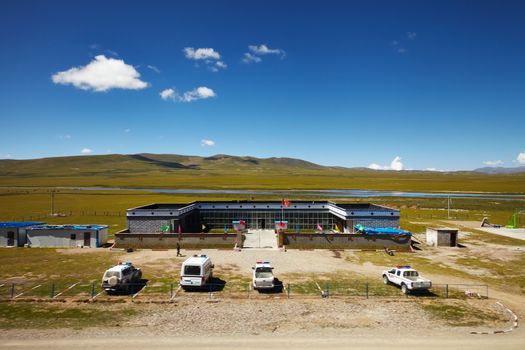 A chinese army outpost in Tibetan Plateau with mountain landscape in the background