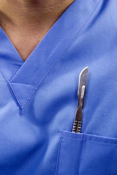 Surgical scalpel in his pocket uniforms. Medicine.
