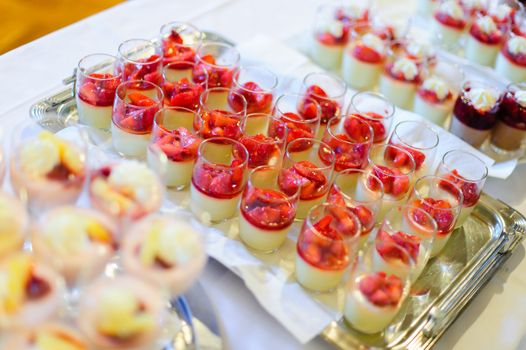 Buffet with different cream dessert in a glass