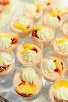 Cream desserts in a row on a buffet