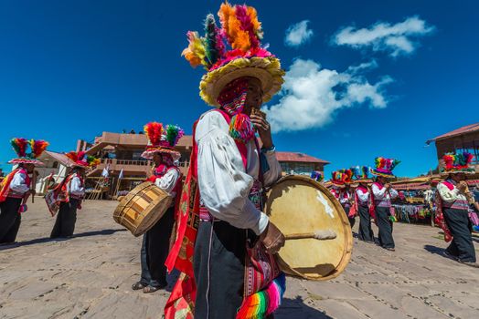 Puno, Peru - July 25, 2013: musicians and dancers in the peruvian Andes at Taquile Island on Puno Peru at july 25th, 2013.