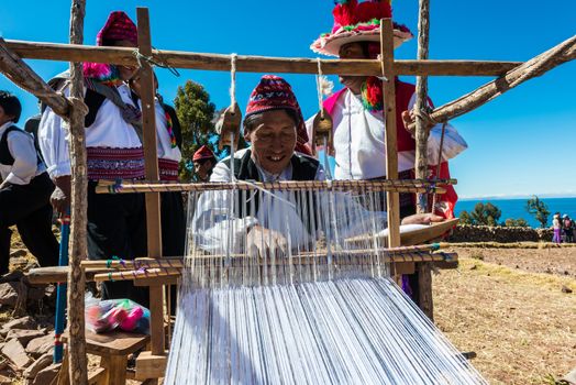 Puno, Peru - July 25, 2013: men weaving in the peruvian Andes at Taquile Island on Puno Peru at july 25th, 2013.