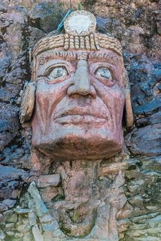 Inca face sculpture in the peruvian Andes at Puno Peru