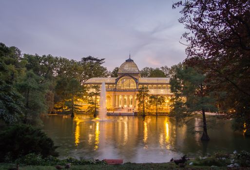 Buen Retiro park lake in Madrid with the famous crystal palace on background