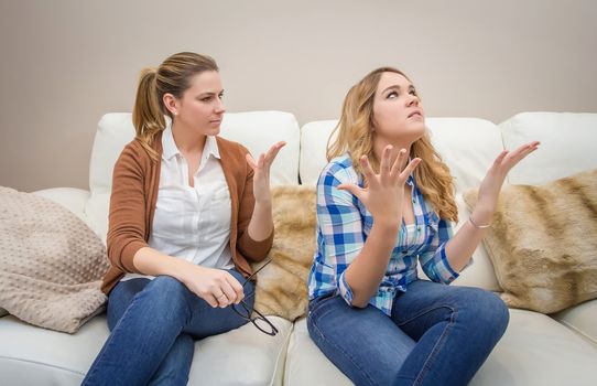 Furious young mother in a discussion with her teenage daughter. Problems between generations concept