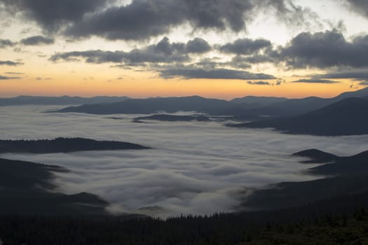 Sunrise in the mountains above the clouds