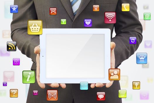 Businessman in a suit holding a tablet computer. Around tablet application icons