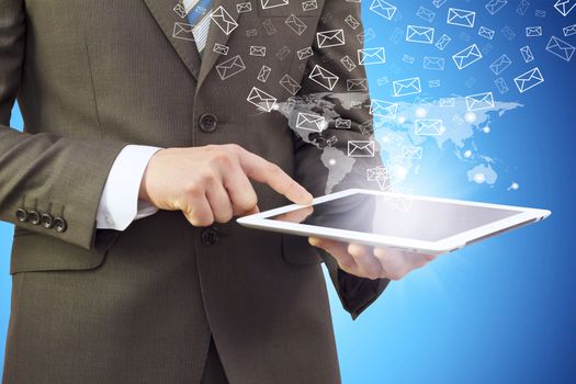 Businessman in a suit holding a tablet computer. Letters icons fly out of the tablet