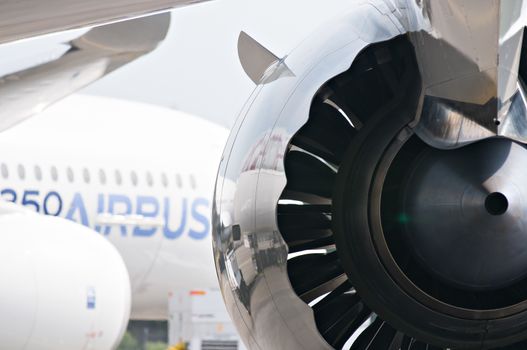 SINGAPORE - FEBRUARY 11: Engine of Qatar Airways Boeing 787 Dreamliner with Airbus A350 XWB in the background at Singapore Airshow, Changi Exhibition Centre in Singapore on February 11, 2014.