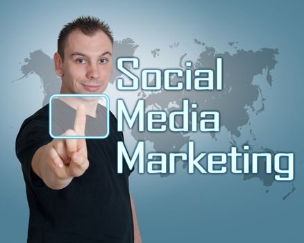 Young man press digital Social Media Marketing button on interface in front of him