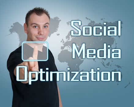Young man press digital Social Media Optimization button on interface in front of him