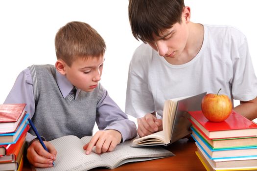 Older Brother helps Little Brother with a homework on the white background