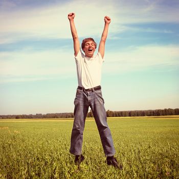 Vintage photo of Happy Teenager jumping on the Meadow