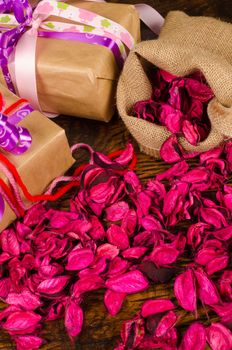 Valentine gifts surrounded by dried flower petals