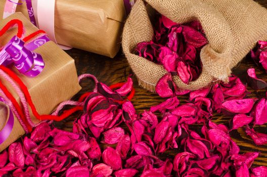 Valentine gifts surrounded by dried flower petals