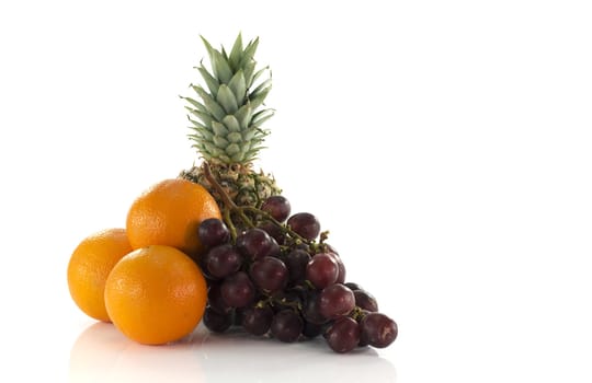 red grapes oranges and pineapple  fruit isolated on white