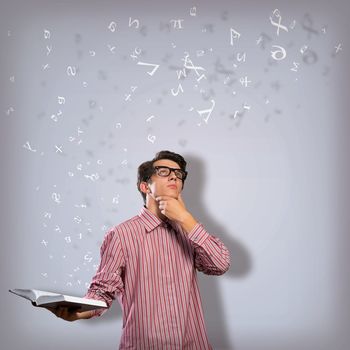 young scientist holding a book, fly out different ideas. concept of creativity