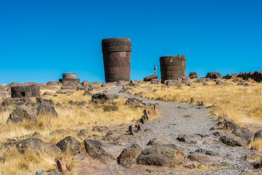 Tourist at the Silustani tombs in the peruvian Andes at Puno Peru