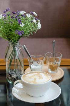Cup of hot Coffee with sugar and imitation cream