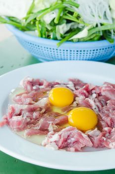 raw meat and  fresh sliced pork , yolk egg  prepare for cooking.