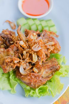 fried chicken served with fresh vegetable and chili sauce