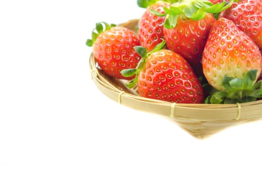 fresh red strawberries on wooden basket over white background