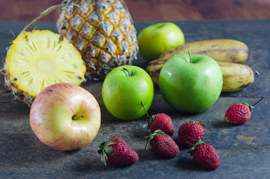 still life of mix fruits , apple with strawberry, pineapple and banana