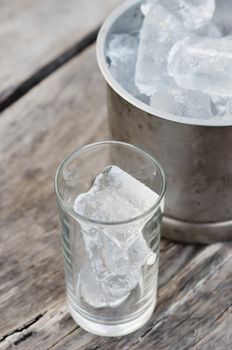 close up Glass with ice cubes and Ice bucket filled with ice cubes