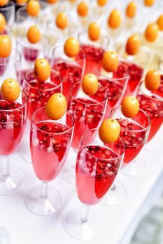 lot of red sparkling drinks on buffet table