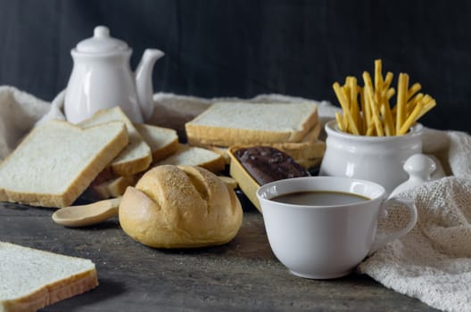 hot coffee with fresh bread on wooden table ,  still life