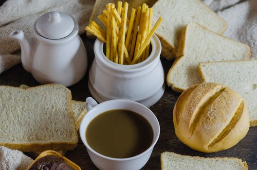 top view hot coffee with fresh bread on wooden table ,  still life