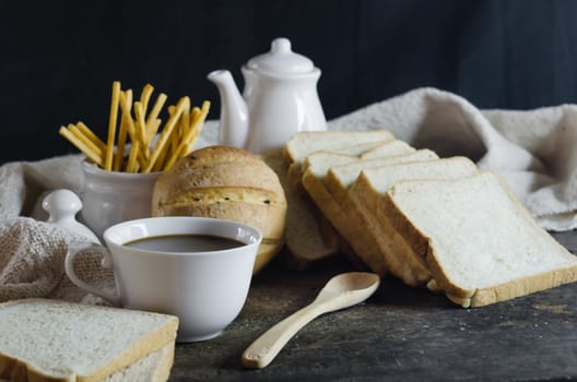 hot coffee with mix  bread on wooden table ,  still life