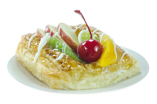 close up Apple Danish Topped With Glazed Fresh Fruit on dish 